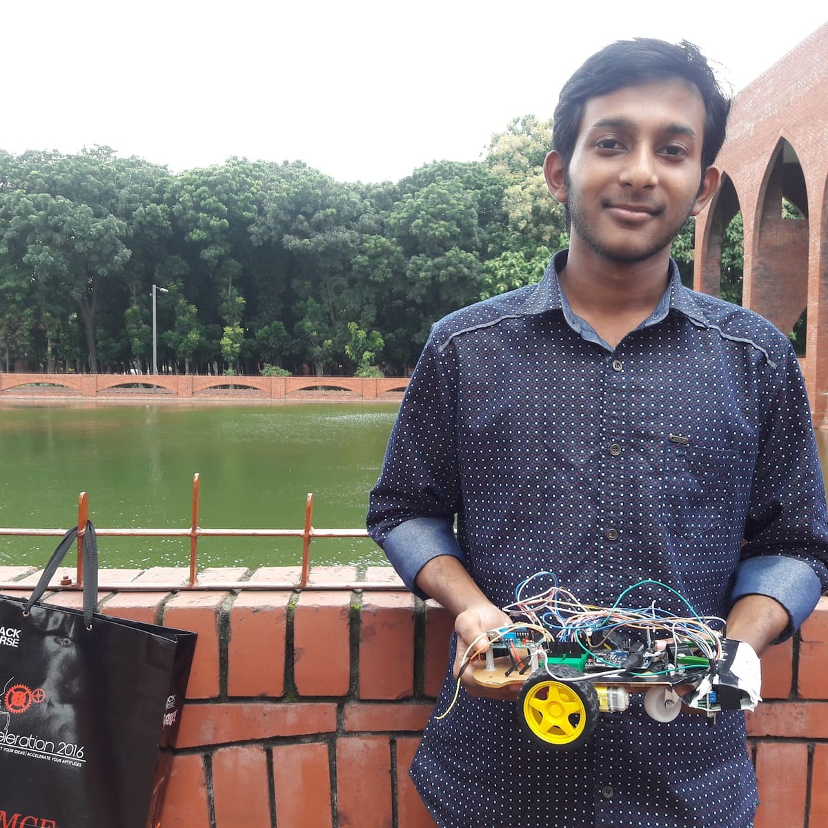 Holding a small robot car outdoors at IUT Mecceleration